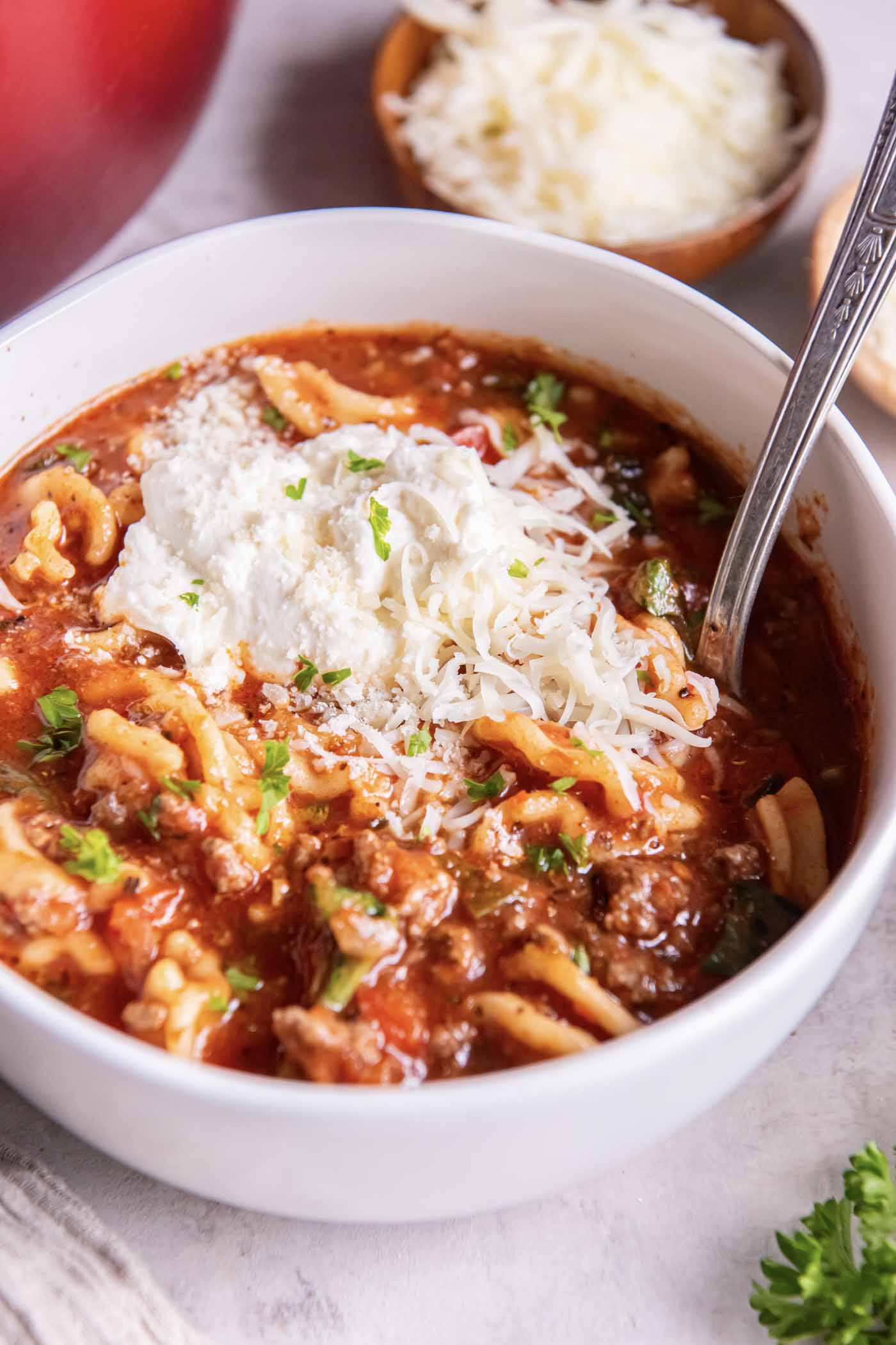 The BEST Ground Turkey Recipes for dinner! These easy, healthy recipes are simple to make and so delicious! Turkey meatballs, turkey chili, turkey meatloaf and more family dinner ideas! Lasagna soup in a bowl topped with ricotta, mozzarella and parmesan cheeses.